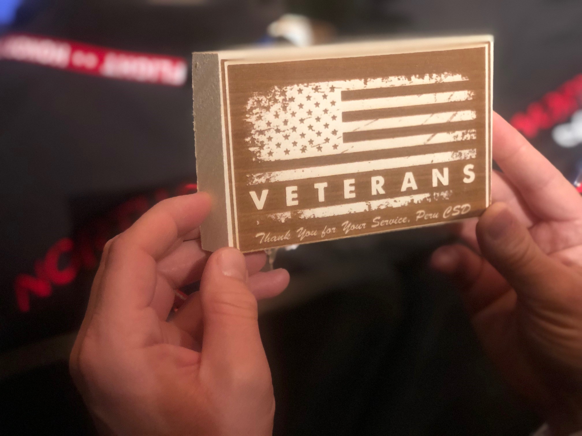 Veteran holding a block honoring all Veterans