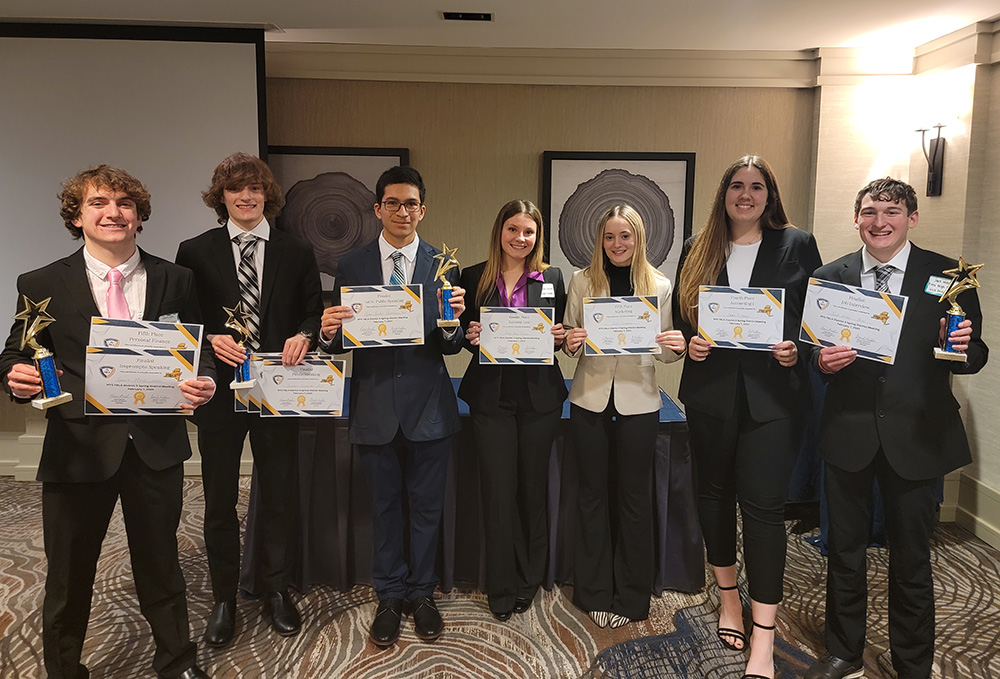 Award winners holding their certificates.